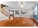 Bright living room showcases hardwood floors, open layout, staircase, and elegant lighting fixture at 218 Austin Creek Ct, Summerville, SC 29483