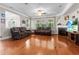 Comfortable living room boasts hardwood floors, fireplace, ceiling fan, and plentiful natural light at 218 Austin Creek Ct, Summerville, SC 29483