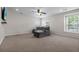 Cozy living room with a comfortable gray couch, carpet flooring, and large windows at 218 Austin Creek Ct, Summerville, SC 29483