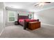 A spacious main bedroom featuring a large bed, ceiling fan, and natural light at 218 Austin Creek Ct, Summerville, SC 29483