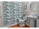 Charming powder room featuring unique wallpaper, pedestal sink, and modern fixtures at 218 Austin Creek Ct, Summerville, SC 29483