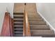 An interior staircase with carpeted steps and a wooden banister at 218 Austin Creek Ct, Summerville, SC 29483
