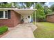 Covered entrance featuring a brick exterior, white trim, and a well-lit entryway at 2220 Pinehurst Ave, Charleston, SC 29414