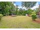 Expansive backyard featuring a trampoline, storage shed, and spacious lawn, providing ample space for outdoor activities at 2220 Pinehurst Ave, Charleston, SC 29414