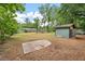 Large backyard featuring mature trees, a storage shed, and concrete pad, perfect for outdoor living at 2220 Pinehurst Ave, Charleston, SC 29414