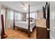 Bright bedroom features a four-poster bed, hardwood floors, and neutral walls, providing a comfortable and serene space at 2220 Pinehurst Ave, Charleston, SC 29414