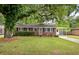 Traditional brick home showcasing a well-maintained lawn and a covered carport, exuding classic curb appeal at 2220 Pinehurst Ave, Charleston, SC 29414