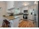 Bright kitchen featuring granite countertops, stainless steel appliances, and hardwood floors at 2220 Pinehurst Ave, Charleston, SC 29414