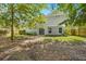 Backyard with lush lawn and partial view of the house from behind shade trees and foliage at 240 Eagle Ridge Rd, Summerville, SC 29485