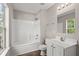 Bathroom features a tub and shower combination, toilet, sink, mirror, and wood-look floors at 240 Eagle Ridge Rd, Summerville, SC 29485