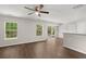 Spacious living room with wood-look floors, large windows, and sliding glass doors to backyard at 240 Eagle Ridge Rd, Summerville, SC 29485