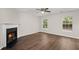 Bright living room featuring a cozy fireplace, modern ceiling fan, and ample natural light at 240 Eagle Ridge Rd, Summerville, SC 29485