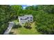 Scenic aerial view of a home nestled among lush trees, with a long driveway, highlighting privacy and natural surroundings at 25 Fitzroy Dr, Charleston, SC 29414