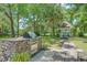 Landscaped backyard featuring a built-in outdoor grill and a charming gazebo with blue benches at 25 Fitzroy Dr, Charleston, SC 29414