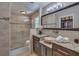 Beautiful bathroom featuring granite counters, dark cabinets, travertine tile, and a glass enclosed shower at 25 Fitzroy Dr, Charleston, SC 29414