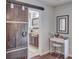 View through a wooden sliding barn door into the main bathroom with bright vanity at 25 Fitzroy Dr, Charleston, SC 29414