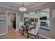 Cozy dining area with views of the living room fireplace and staircase in this charming home at 25 Fitzroy Dr, Charleston, SC 29414