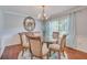 Elegant dining room featuring a glass table, chandelier, and views of the outdoors through window at 25 Fitzroy Dr, Charleston, SC 29414