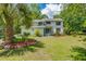 Charming two-story home with a manicured lawn, palm tree, and inviting entrance exudes curb appeal and Southern charm at 25 Fitzroy Dr, Charleston, SC 29414