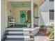 Inviting front porch featuring a charming blue door, stylish decor, and comfortable seating at 25 Fitzroy Dr, Charleston, SC 29414