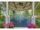 Charming gazebo with blue rocking chairs surrounded by bright pink flowers in a peaceful setting at 25 Fitzroy Dr, Charleston, SC 29414