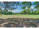 Scenic view of a lush golf course with mature trees and blue skies, offering a tranquil setting at 25 Fitzroy Dr, Charleston, SC 29414