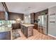 Charming kitchen featuring granite countertops, wooden cabinets, stainless steel appliances, and a wine fridge at 25 Fitzroy Dr, Charleston, SC 29414