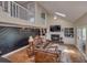 Bright living room with a fireplace, skylight, and staircase leading to the upper floor at 25 Fitzroy Dr, Charleston, SC 29414