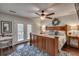 Bright main bedroom with a ceiling fan, a decorative wreath, and access to the balcony at 25 Fitzroy Dr, Charleston, SC 29414
