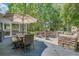 Wood deck featuring an outdoor kitchen, dining area with umbrella, and a stone grill for outdoor cooking at 25 Fitzroy Dr, Charleston, SC 29414