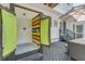Charming outdoor shower on the deck with colorful doors and a view of the surrounding greenery and patio at 25 Fitzroy Dr, Charleston, SC 29414
