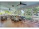 Relax in this screened porch with ample seating and views of the lush backyard and nearby fields at 25 Fitzroy Dr, Charleston, SC 29414