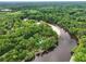 Aerial view of property nestled among lush greenery and the tranquil river, in a serene natural setting at 263 Gator Walk, Ridgeville, SC 29472