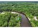 Aerial view of a house with waterfront access surrounded by lush green forest at 263 Gator Walk, Ridgeville, SC 29472