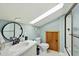 Bathroom with natural light from a skylight, vanity with a round mirror, toilet and walk-in shower at 263 Gator Walk, Ridgeville, SC 29472