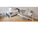 Bedroom featuring a queen bed, a futon, and wooden floor at 263 Gator Walk, Ridgeville, SC 29472