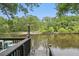 Expansive outdoor deck featuring ample seating and views of the tranquil river at 263 Gator Walk, Ridgeville, SC 29472