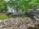 A quaint waterfront home with a dark wooden deck and a rocky shoreline at 263 Gator Walk, Ridgeville, SC 29472