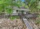Charming home featuring a wooden deck overlooking a rocky landscape, and a ramp leading to the water at 263 Gator Walk, Ridgeville, SC 29472
