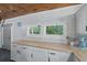 Bright kitchen with white shaker cabinets, herringbone backsplash and butcher block countertops at 263 Gator Walk, Ridgeville, SC 29472
