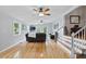 Open living room with hardwood floors, large windows, and a staircase to another level at 263 Gator Walk, Ridgeville, SC 29472