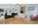 Bright living room featuring hardwood floors, natural light, and a cozy fireplace at 263 Gator Walk, Ridgeville, SC 29472