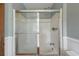 Shower featuring a glass sliding door, bathtub, and updated fixtures in a bright and clean bathroom at 263 Gator Walk, Ridgeville, SC 29472