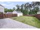 Backyard featuring a lush lawn, a paver patio, wooden fencing and a detached garage at 2844 Pinelog Ln, Johns Island, SC 29455