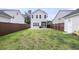 Large backyard with a well-manicured lawn, fence, and view of the home's exterior at 2844 Pinelog Ln, Johns Island, SC 29455