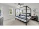 Bright bedroom with a canopy bed, neutral walls, and large window overlooking the yard at 2844 Pinelog Ln, Johns Island, SC 29455
