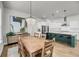 Dining room featuring a stylish chandelier, adjacent to a modern kitchen, and hardwood floors at 2844 Pinelog Ln, Johns Island, SC 29455