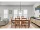 Elegant dining area with a chandelier, hardwood floors, and connectivity to the living room and kitchen at 2844 Pinelog Ln, Johns Island, SC 29455