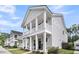 Beautiful two-story home featuring a double porch with white columns and well-maintained landscaping at 2844 Pinelog Ln, Johns Island, SC 29455