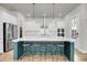 Bright kitchen features an island with seating, stainless appliances, white cabinets, and hardwood flooring at 2844 Pinelog Ln, Johns Island, SC 29455